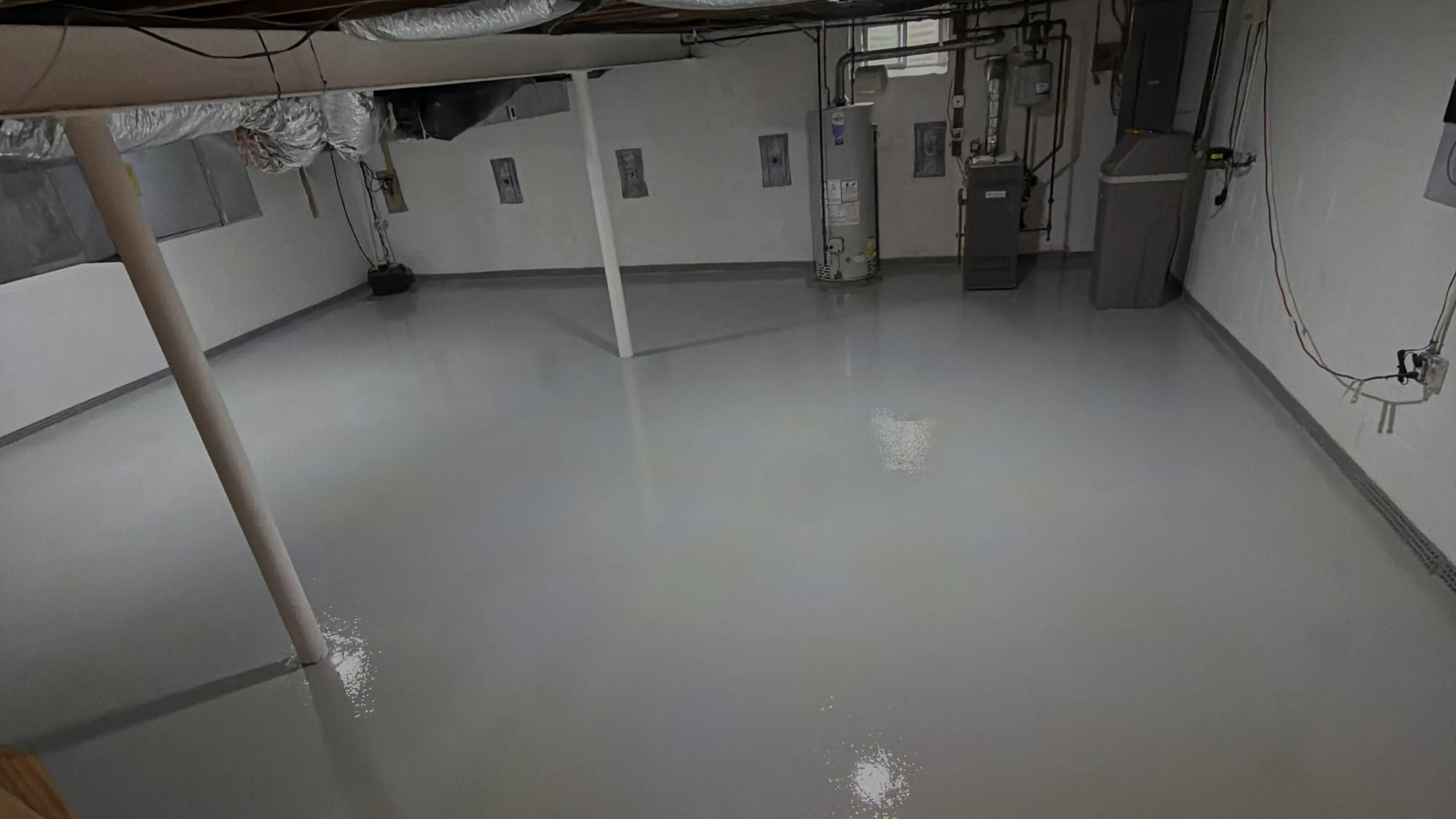 Finished basement floor coated in solid color epoxy by Liberty Epoxy