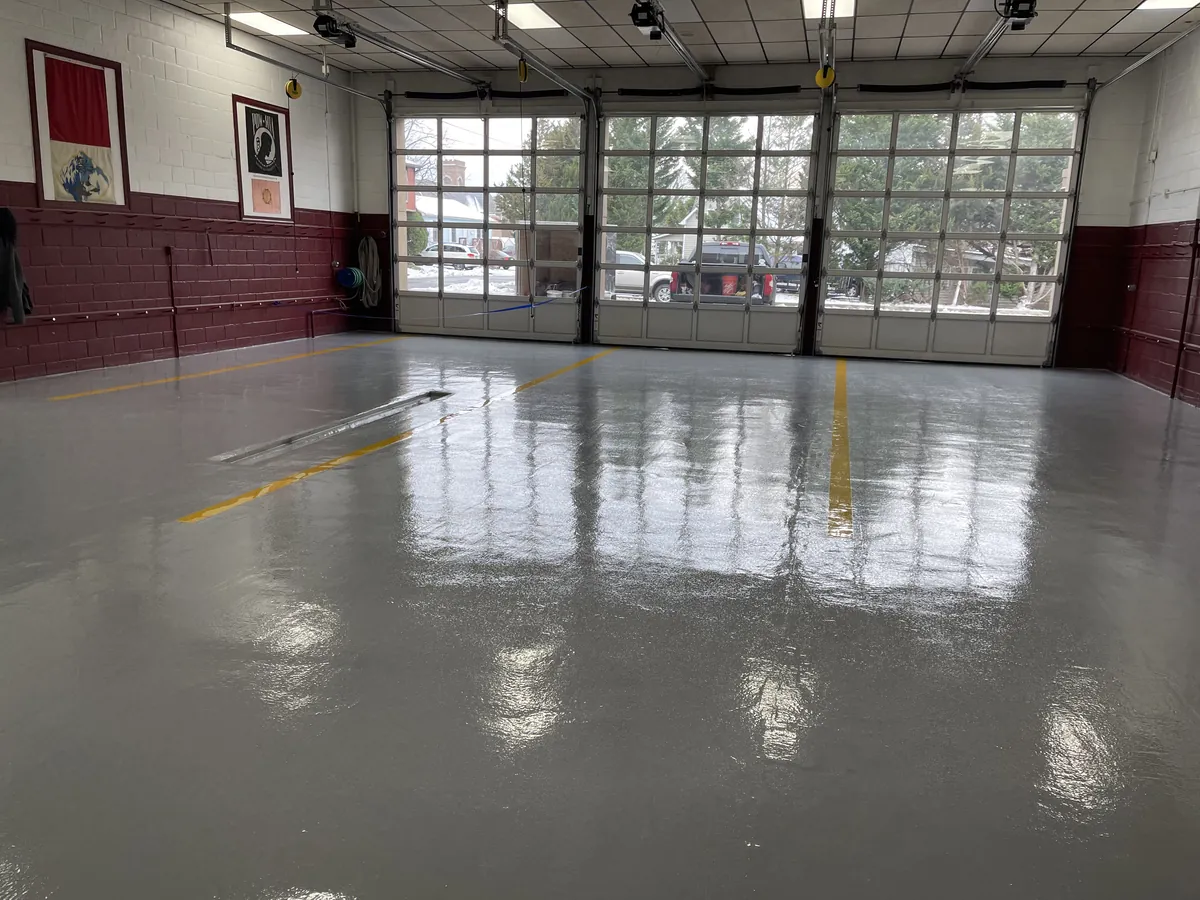 Solid color epoxy floor in a fire company apparatus bay