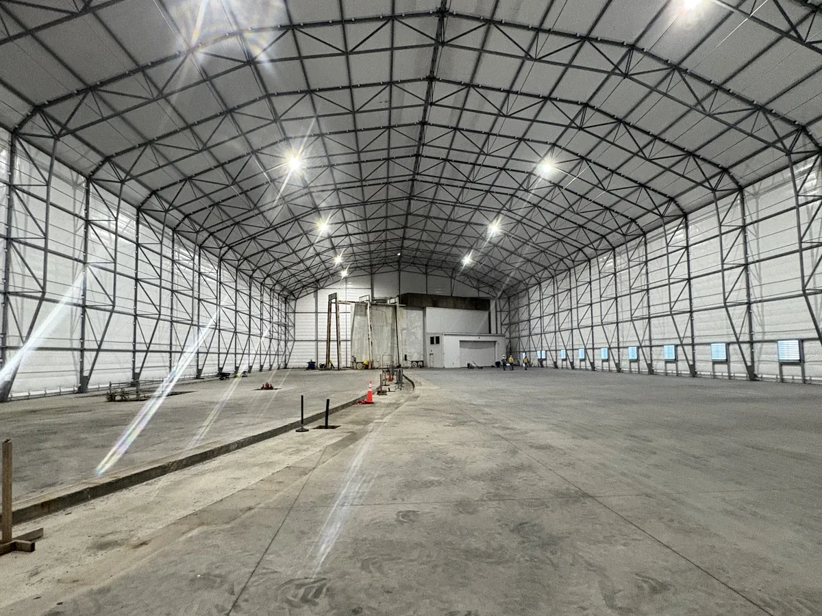 Bare concrete inside a decontamination enclosure at a nuclear power station, before any coating