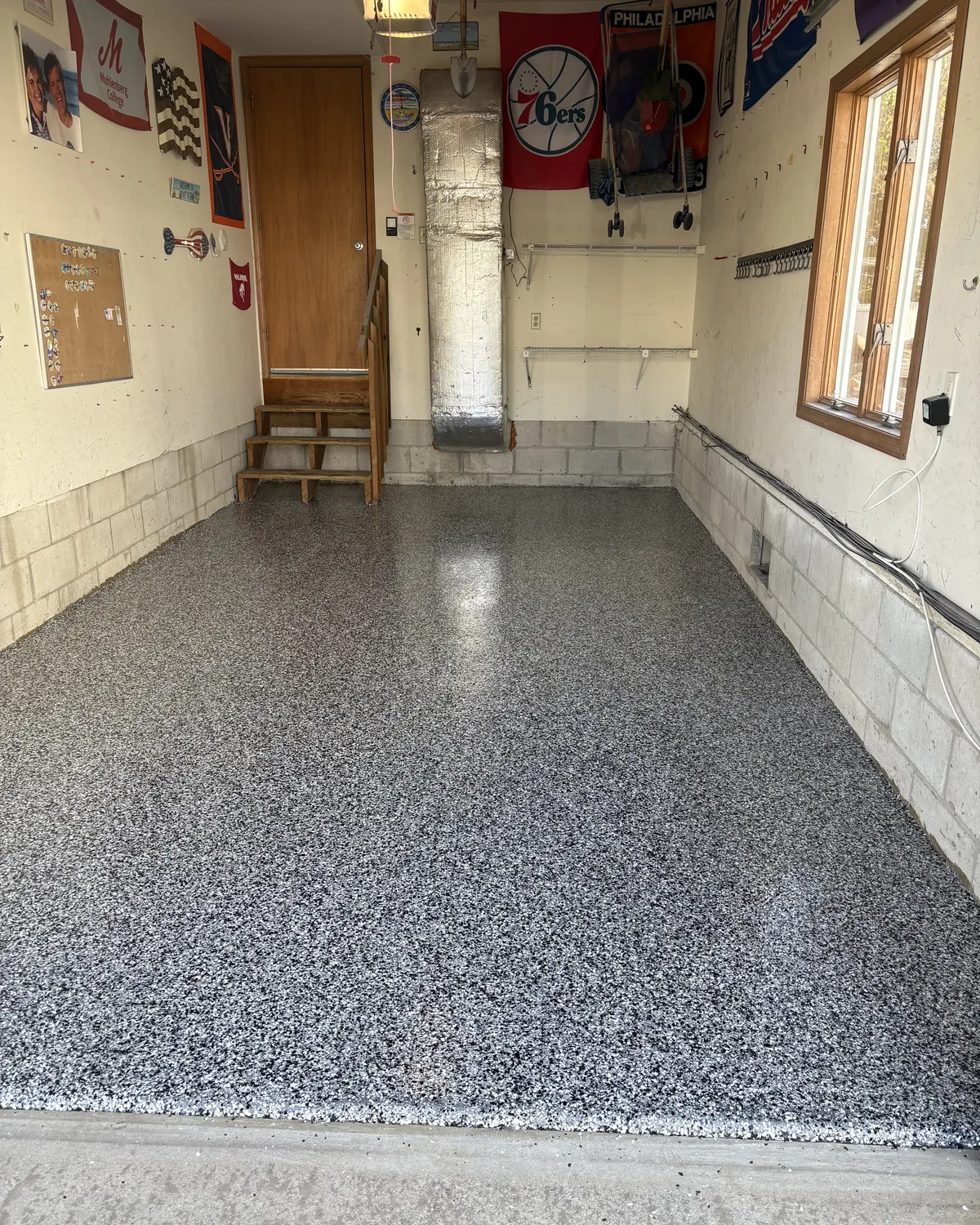 Domino flake garage floor beside raised concrete stem walls