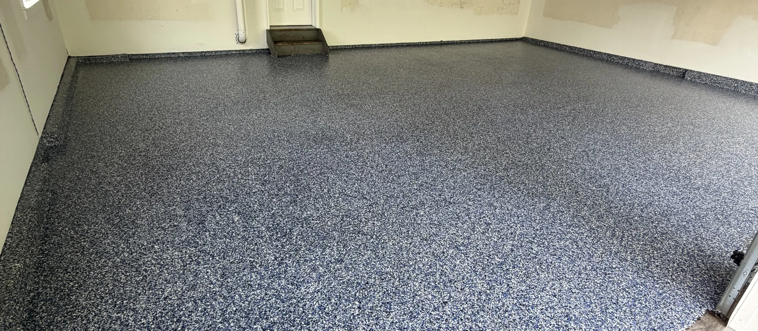 Finished full-broadcast flake garage floor by Liberty Epoxy