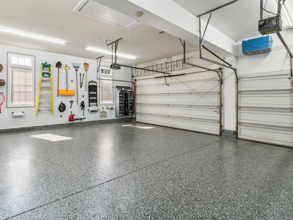 Finished flake epoxy garage floor with the doors open, by Liberty Epoxy