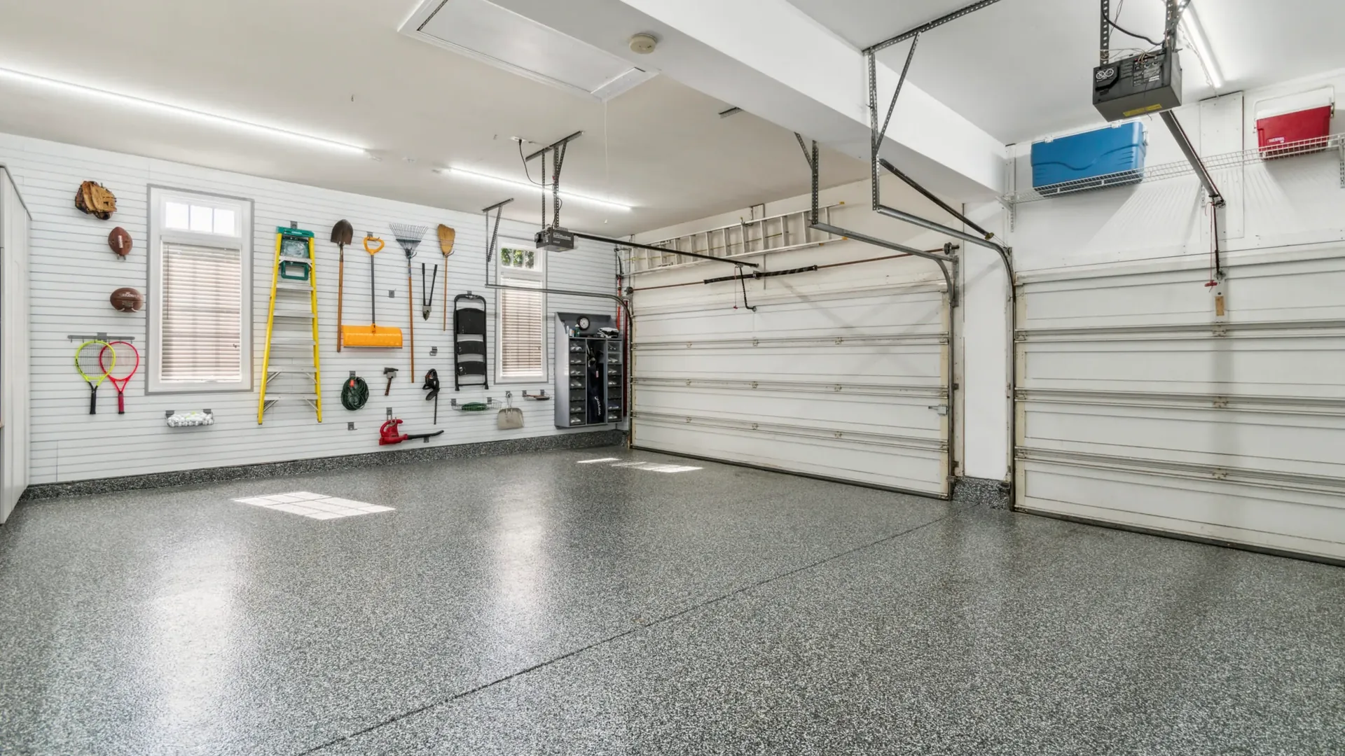 Finished flake epoxy garage floor with the doors open, by Liberty Epoxy