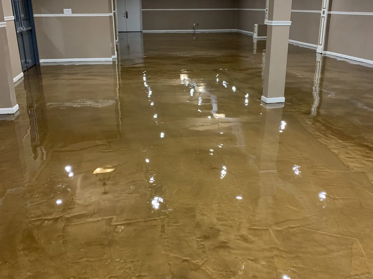 Gold metallic epoxy floor poured through an open-plan interior