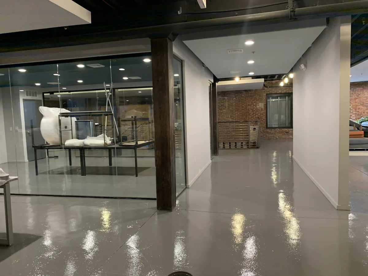 Solid color epoxy floor through a corporate headquarters corridor