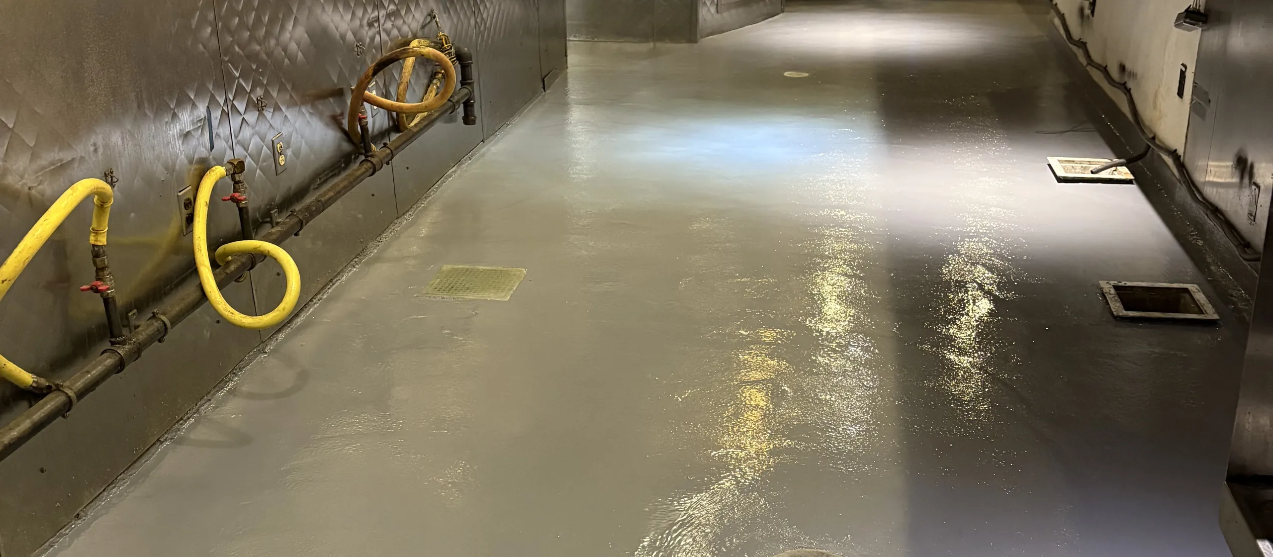 Seamless coated commercial kitchen floor along a grill line