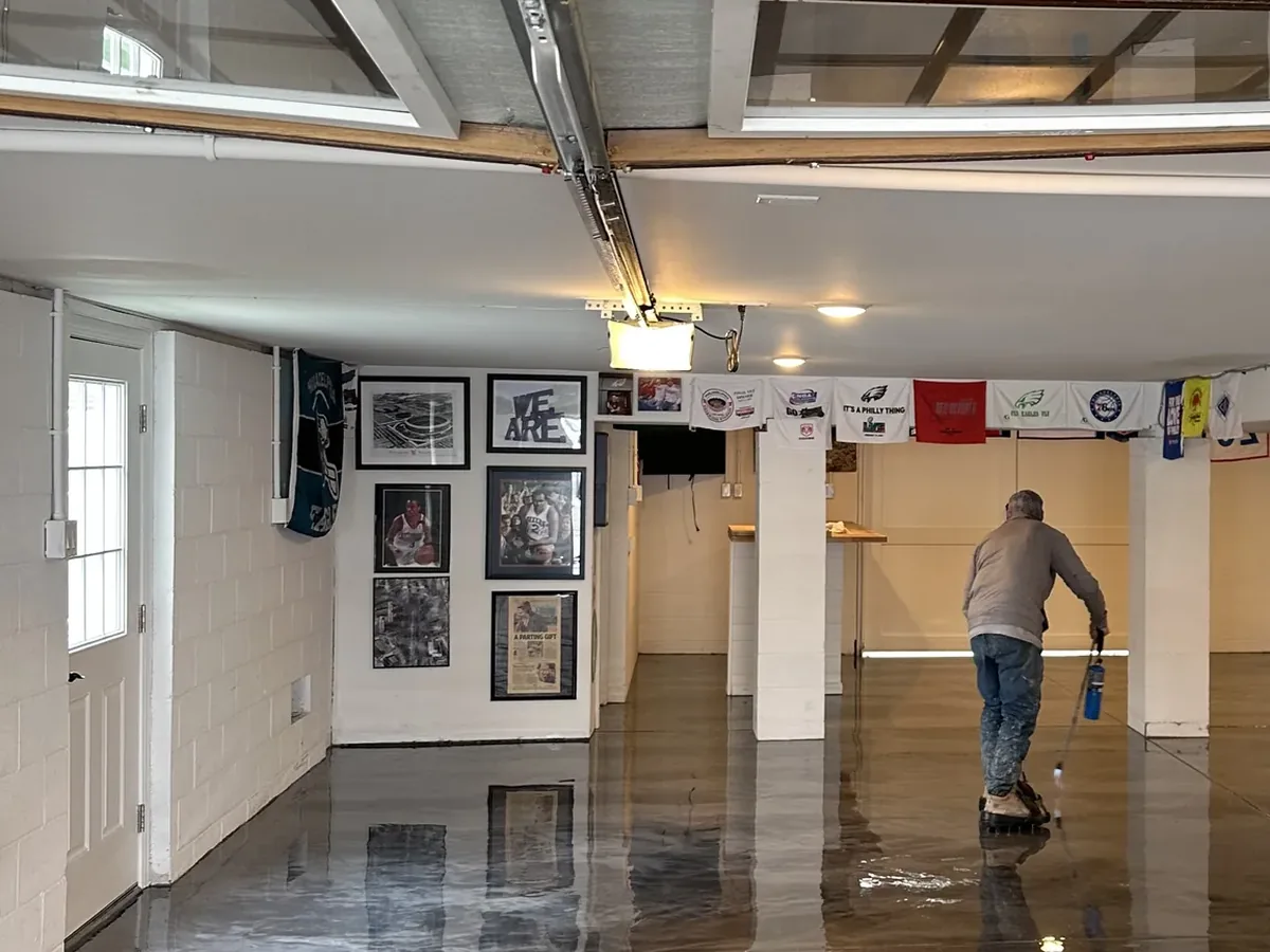 Silver metallic epoxy floor in a finished garage lounge