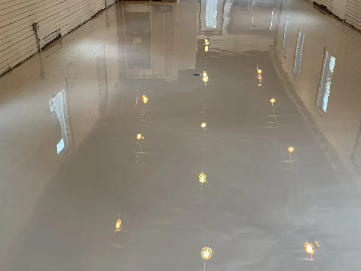 Pearl metallic epoxy floor poured across a wide open room