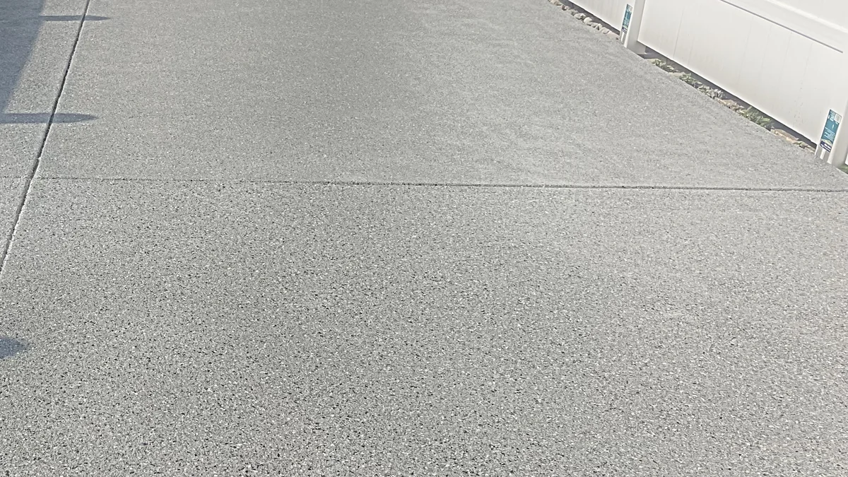 Outdoor flake floor alongside a house, coated by Liberty Epoxy