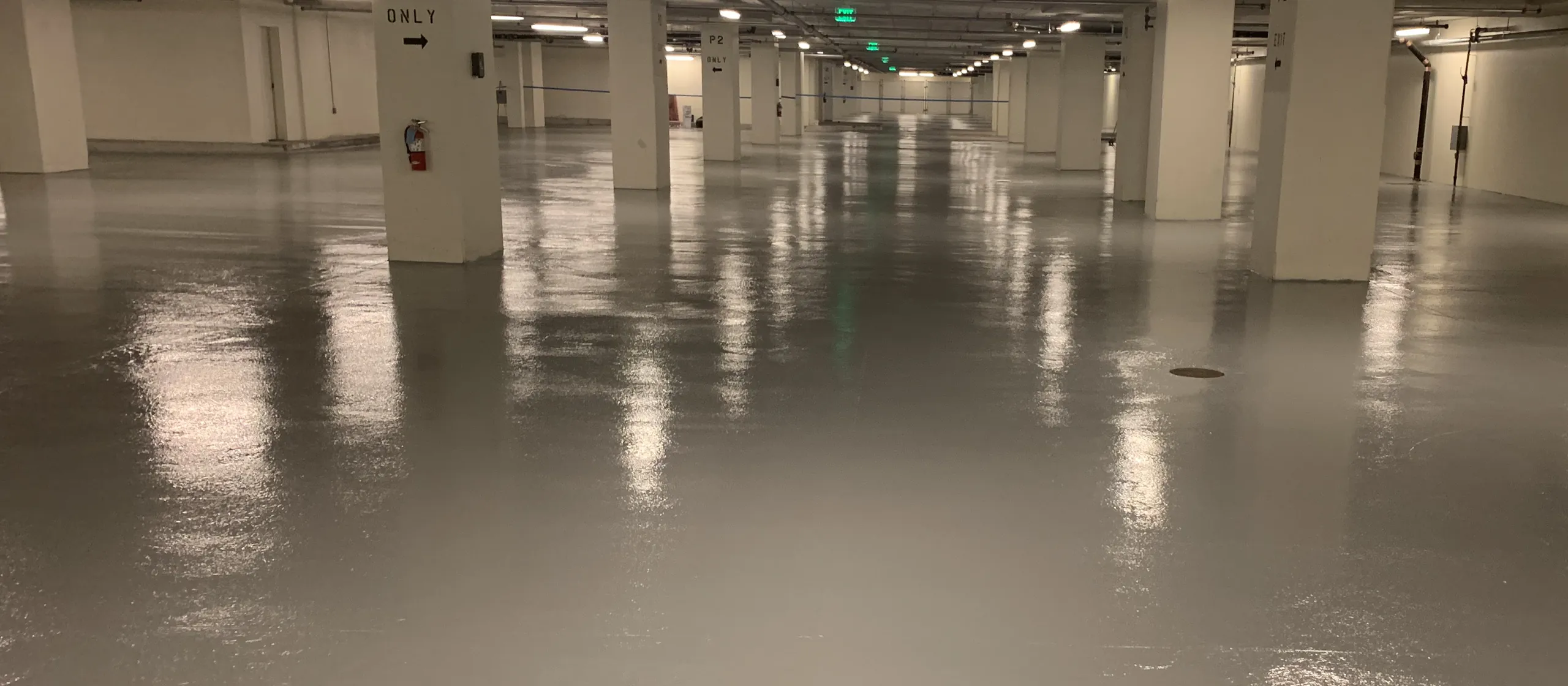 Solid color epoxy floor coating in a commercial parking garage, installed by the Liberty Epoxy crew
