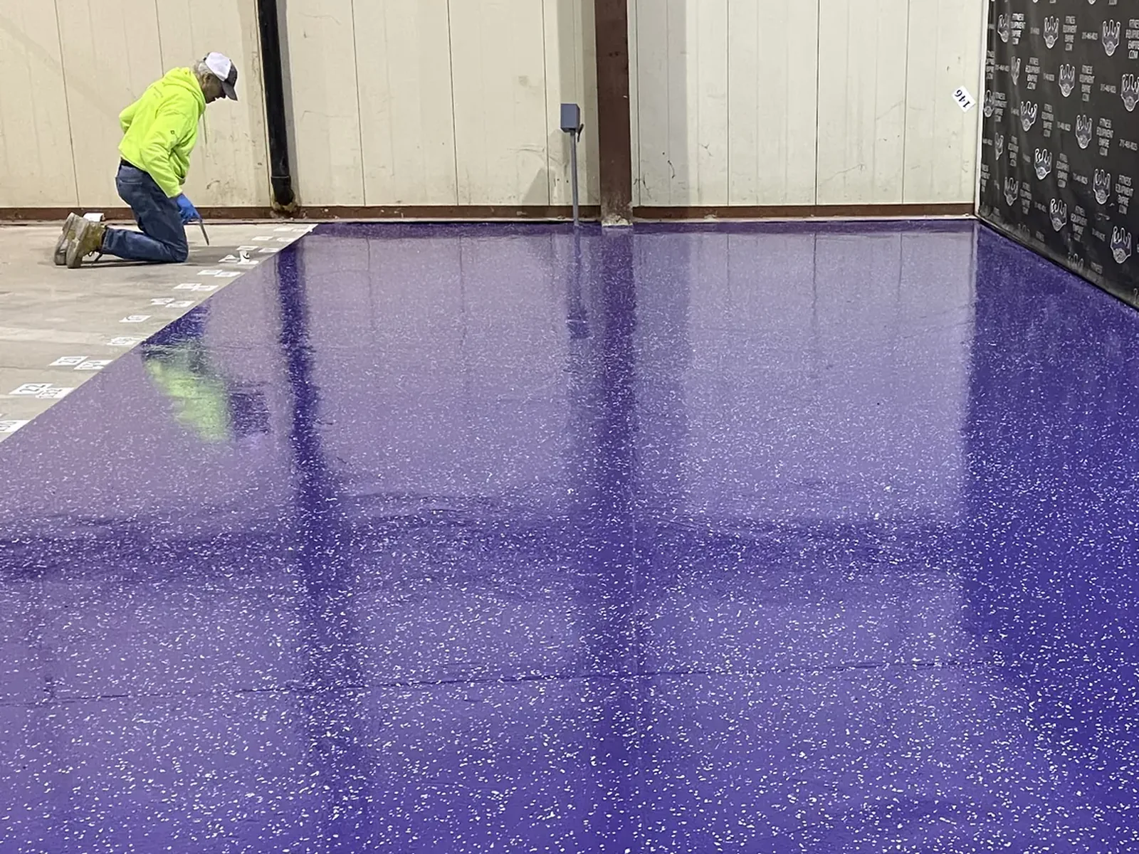 High contrast purple flake epoxy floor, partial broadcast
