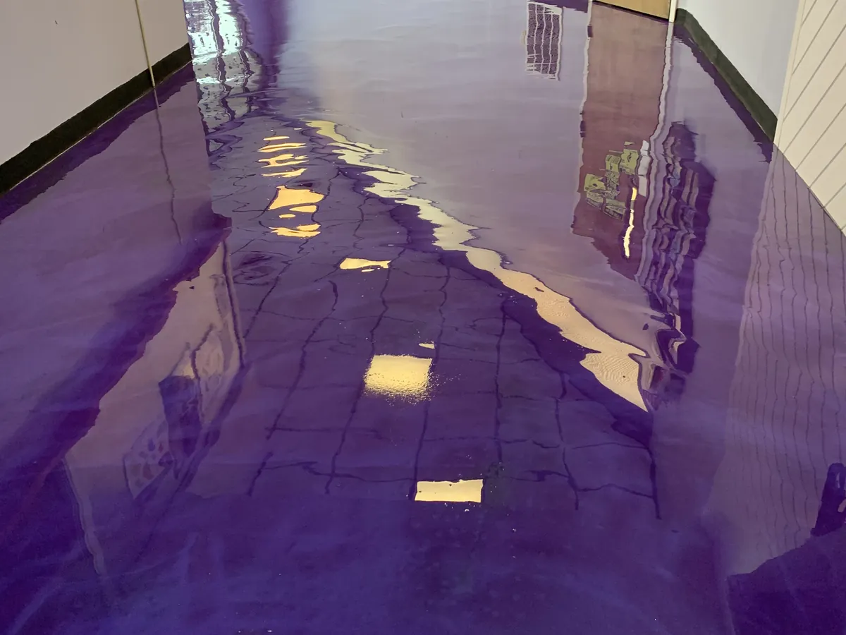 Deep purple metallic epoxy floor in a commercial storefront