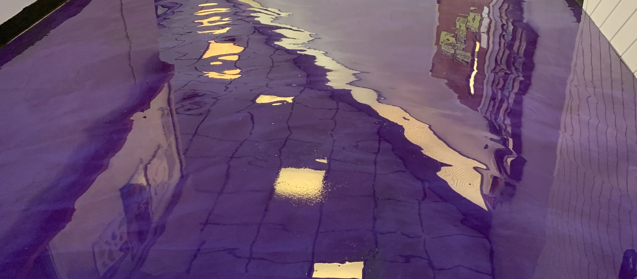 Deep purple metallic epoxy floor in a mirror gloss, hand poured by Liberty Epoxy