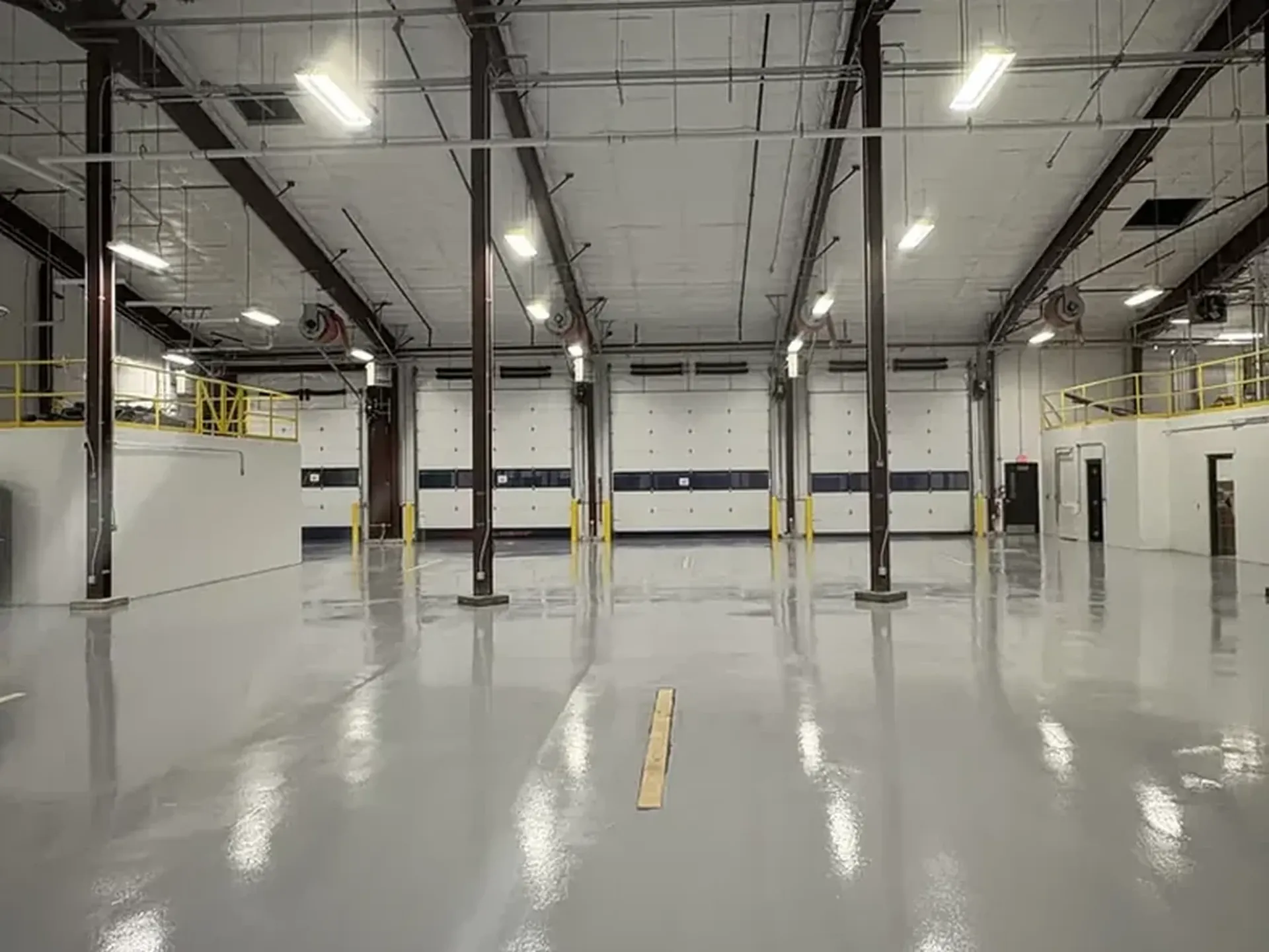 Solid color epoxy floor in a commercial vehicle bay, installed by Liberty Epoxy
