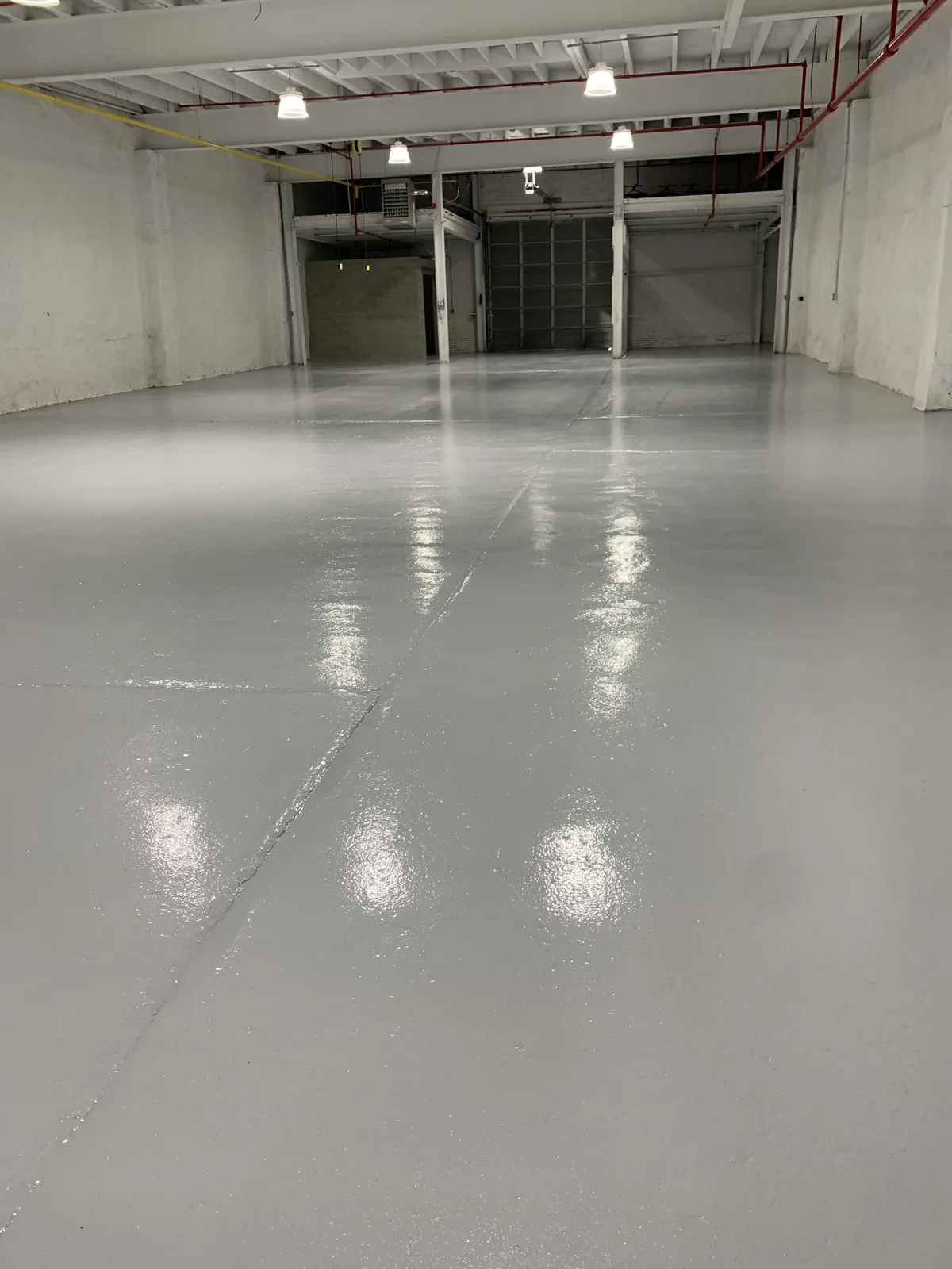 Solid color epoxy floor in a warehouse dock bay