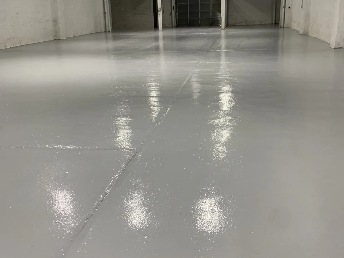 Solid color epoxy floor the length of a warehouse