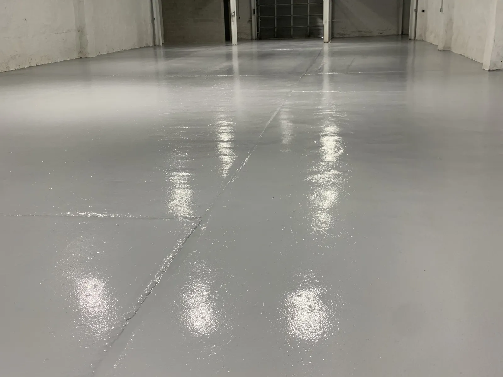 Solid color epoxy floor the length of a warehouse