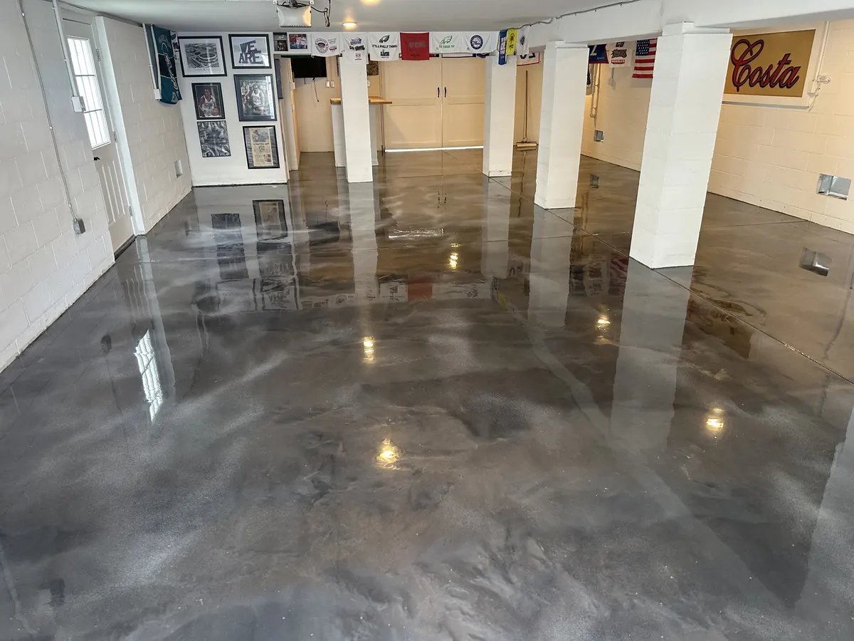 Metallic epoxy floor in a finished live-in garage lounge