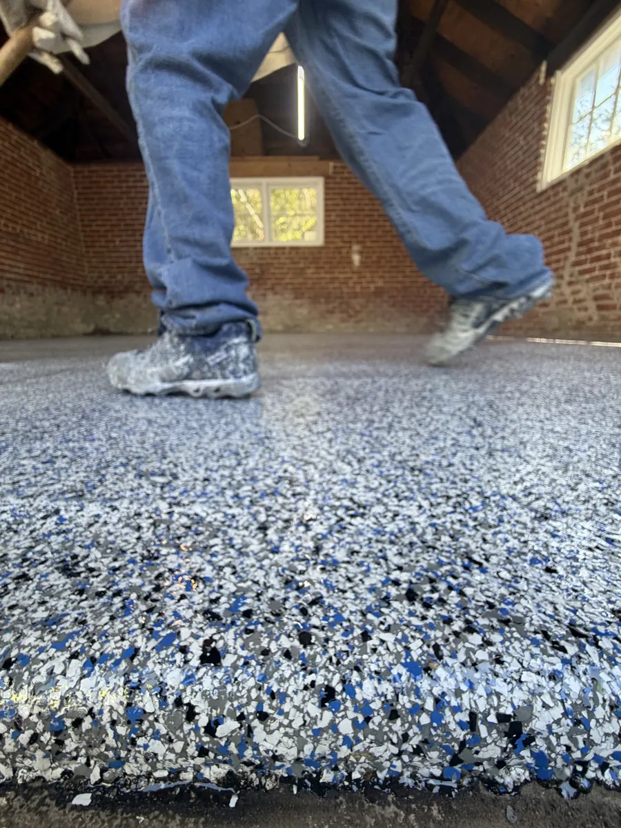 Liberty Epoxy crew broadcasting flake onto a fresh epoxy floor