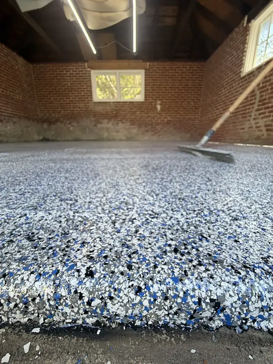 Full-broadcast flake floor mid-scrape before topcoat